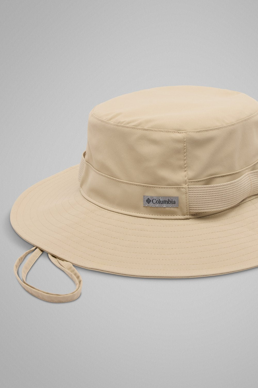 Bob anti-UV packable beige de Columbia, offrant protection solaire UPF 50+ pour activités en plein air.