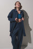 Femme portant une chemise longue anti-UV - Sylt, élégante et légère, avec un pantalon assorti.